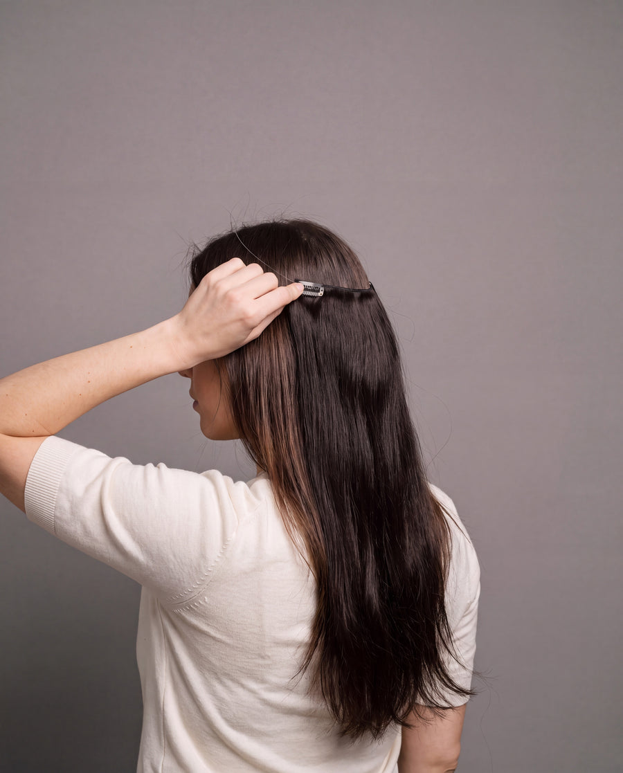 Snapping a Halo clip into her own hair