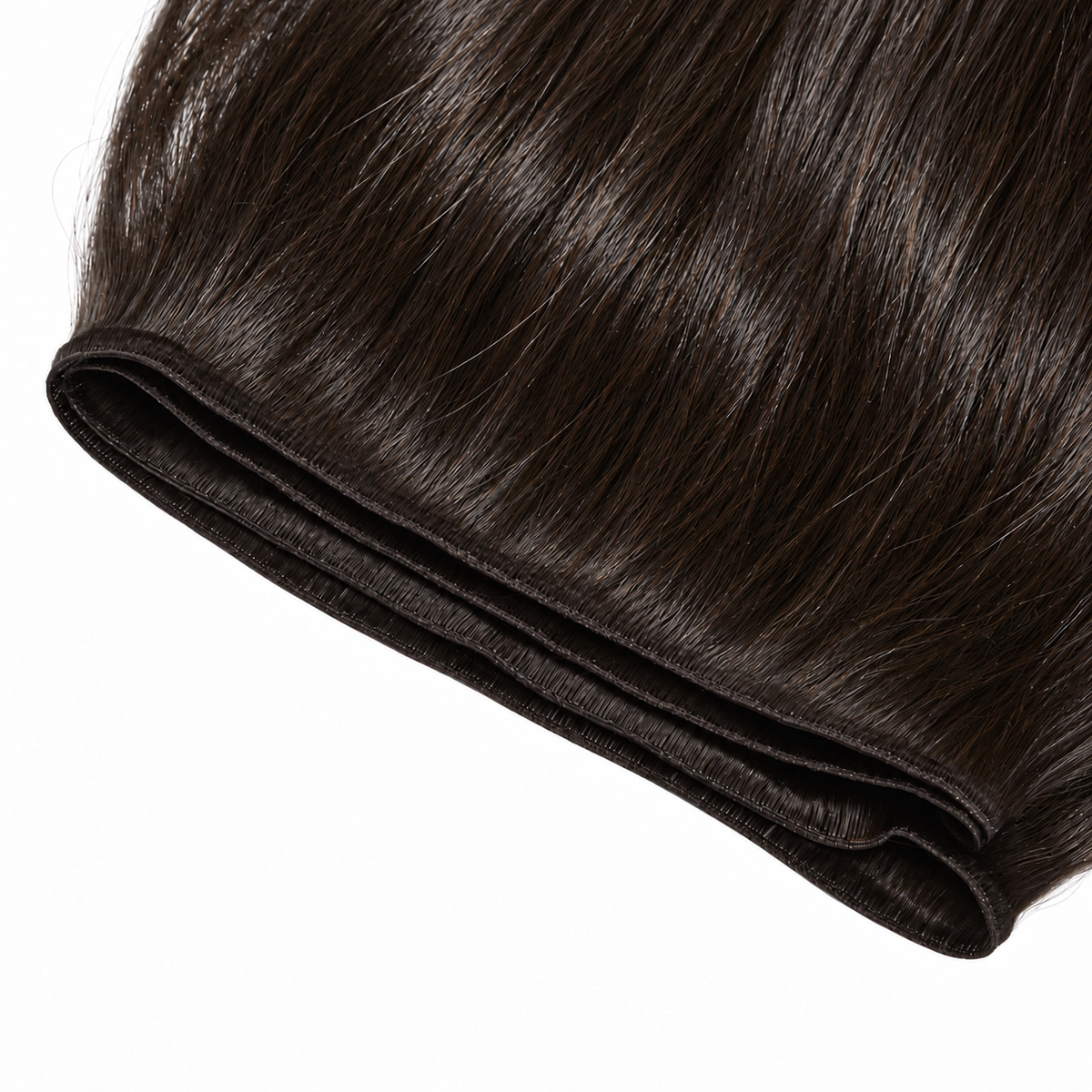 Close-up of dark Genius Weft hair extensions showing flat seams and smooth strands.